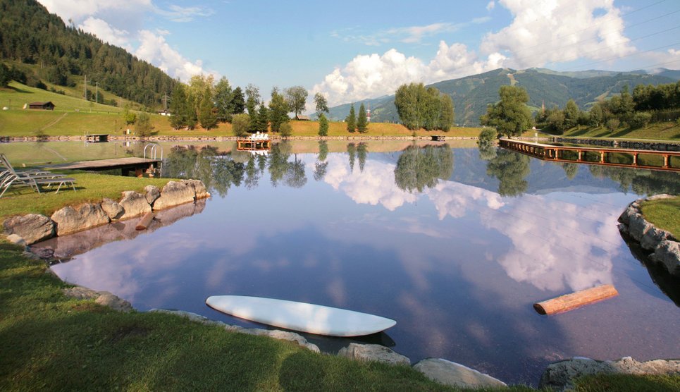 Private swimming lake with sunbathing lawn